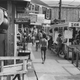 In August 1983, beachgoers and vacationers stroll down Cherry Grove’s business district on Fire Island, New York.